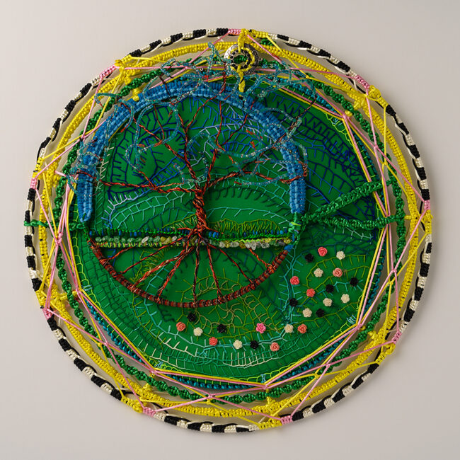 Nature’s Harmony 2, by Judy Phillips, Embroidery background, craft metal sculpture with beads, 20 inch diameter circle