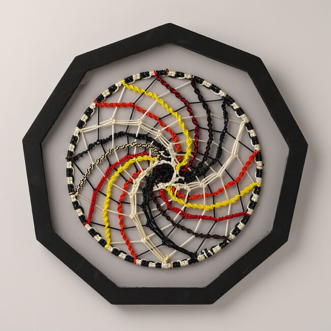 More than Black and White, by Judy Phillips, macrame cording on metal hoop, 18 inch diameter in frame