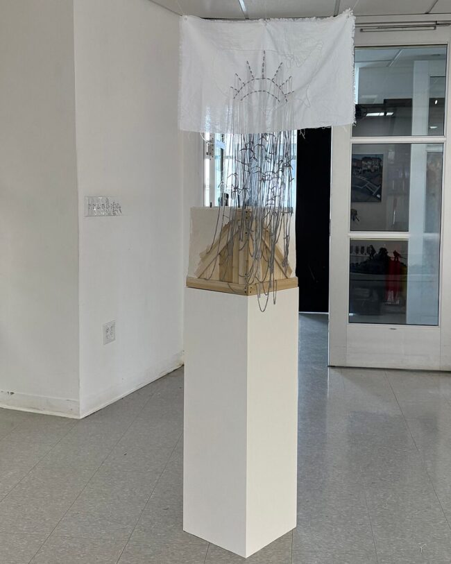 Agnieszka Palka, Human Cargo, Mixed Media including Celluclay, rebar stakes, cardboard, plywood, styrofoam, cotton fabric, yarn, acrylic paint on paper, 37 x 20 x 12 inches